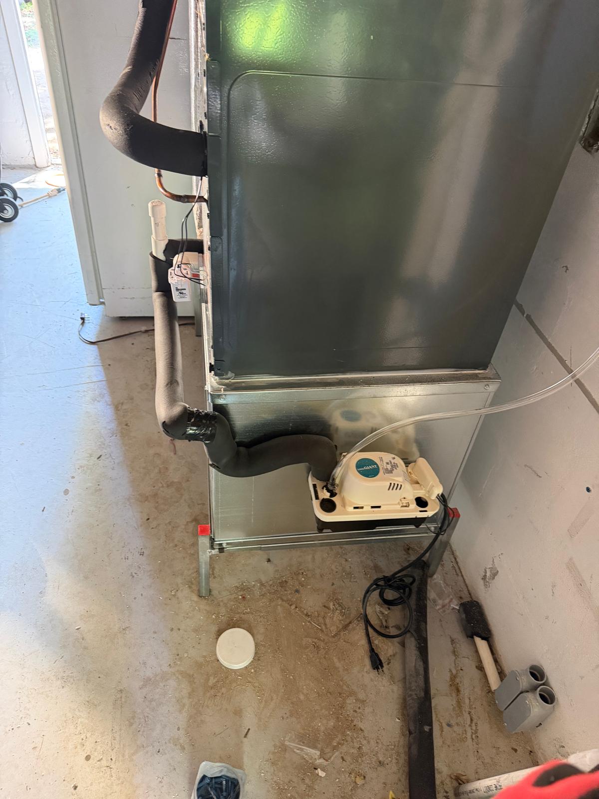 Air handler with condensate pump and new drain lines in a garage