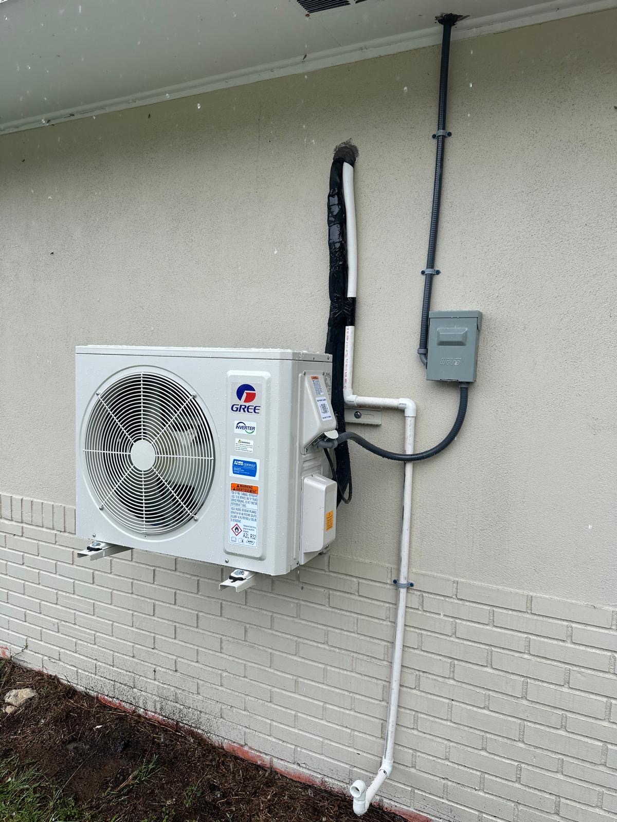 Gree inverter mini split outdoor unit wall-mounted outside a home