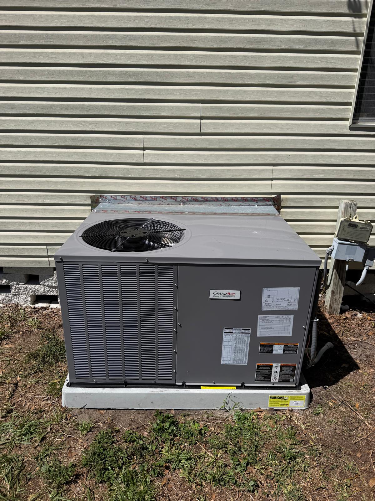 New GrandAire packaged system installed on a pad beside a home