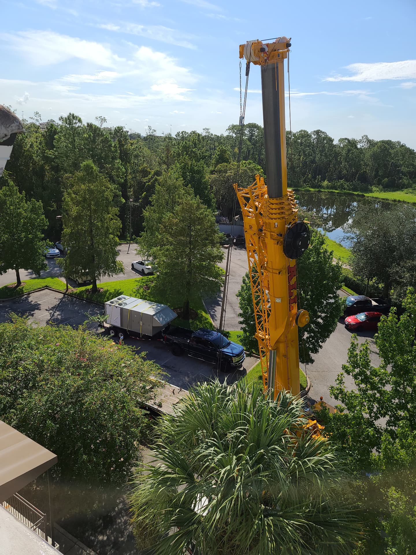Crane setting up at a commercial rooftop unit replacement job